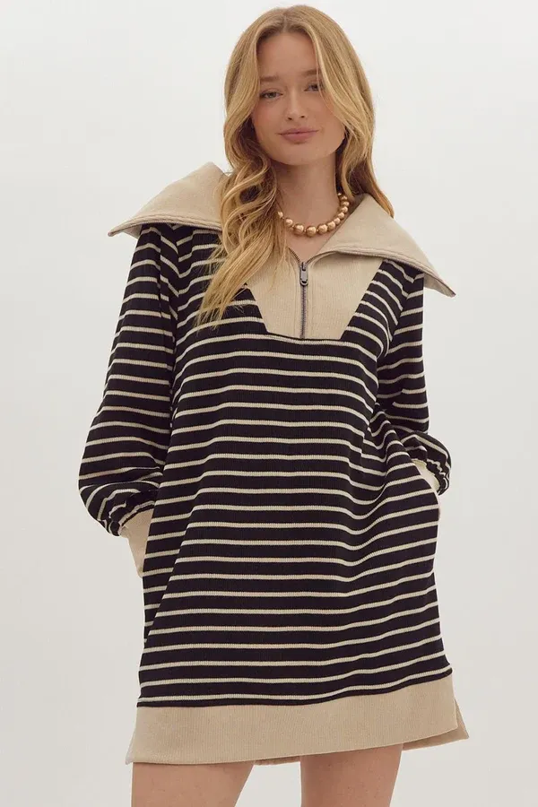 Clothing rack filled with neutral cozy tops and cardigans at Hallie and Company